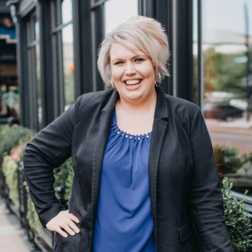 Meahgan Pear has short, blonde hair and wears a blazer over a blue shirt.